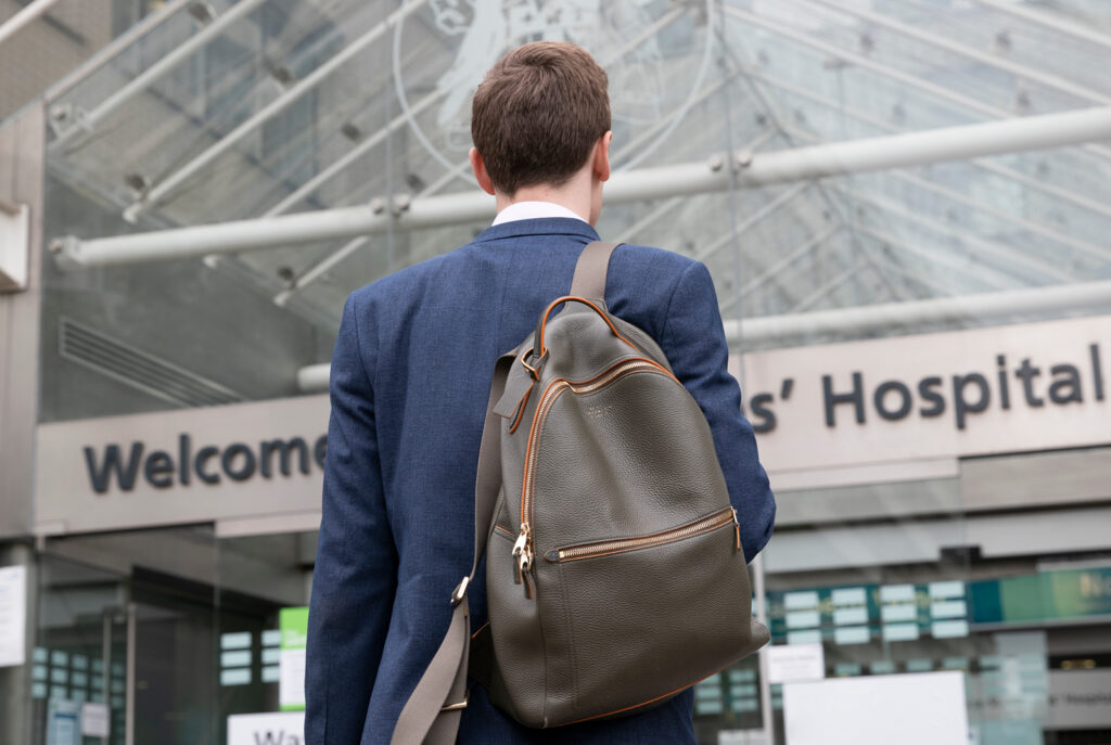 Image of a man walking into a hospital