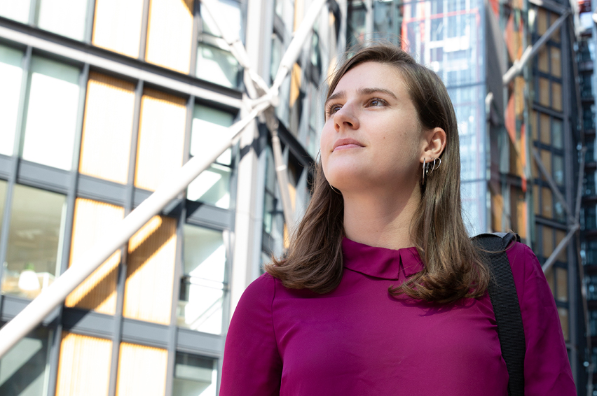 Image of a person with office buildings in the background