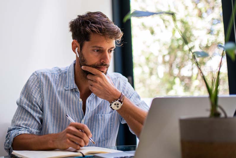 Image of a man working at a computer  