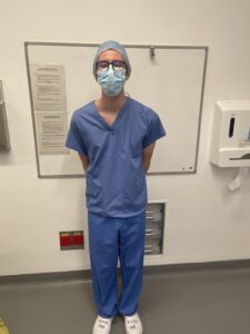Image of a person wearing surgical scrubs in a hospital
