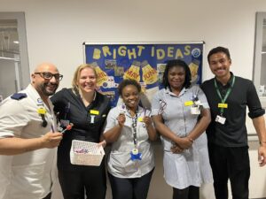 Photo of Andre with a group of people wearing medical uniforms